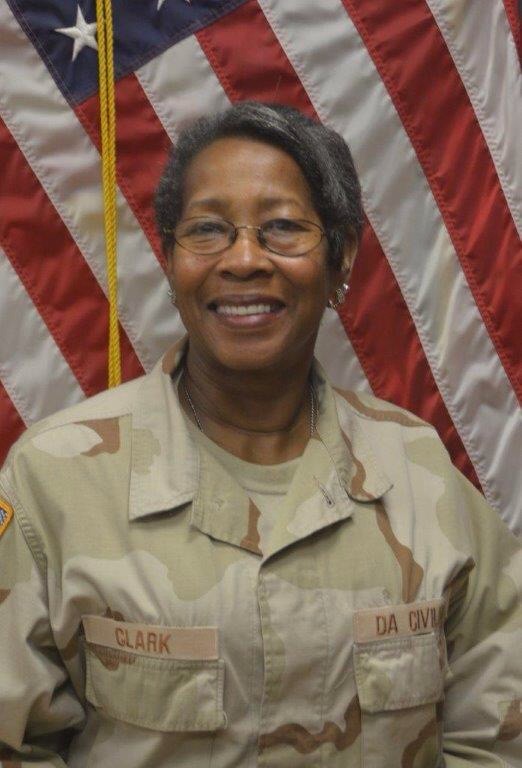 Kaffie Clark in military camo with the american flag as a background